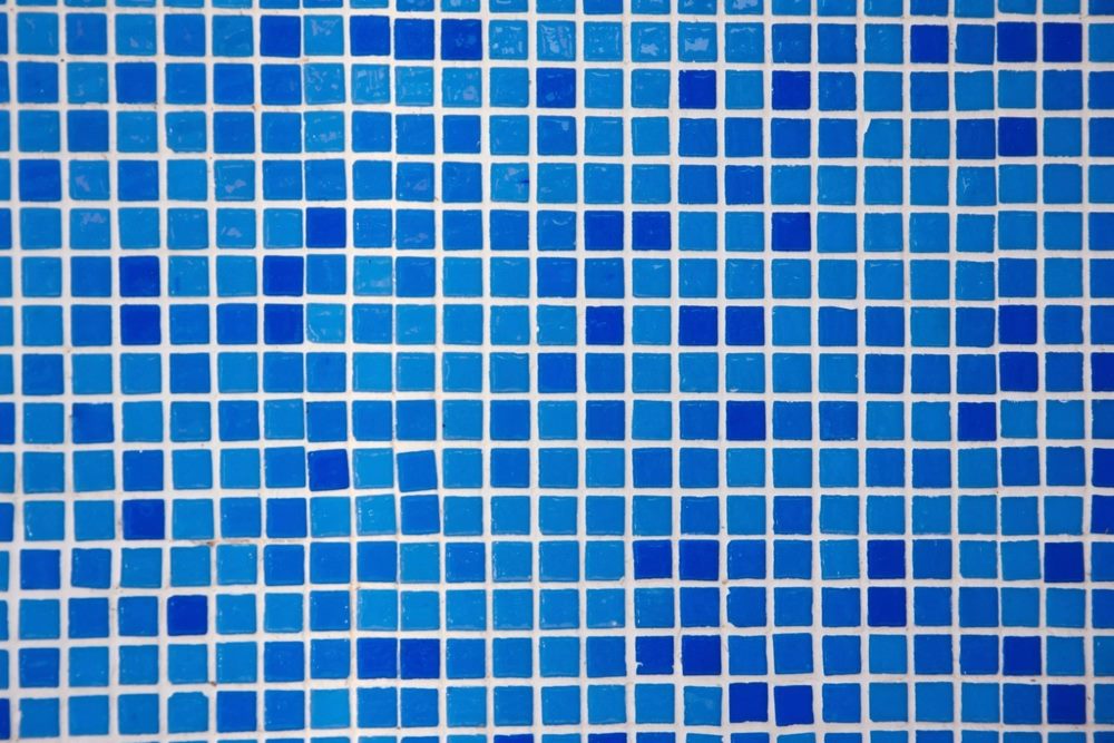 Swimming pool waterproofing system on tiled pool surfaces